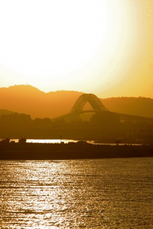 El sol se pone tras el Puente de las Américas